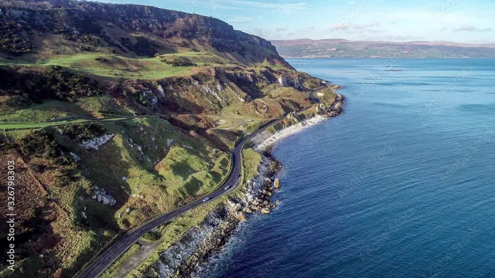 Northern Ireland, UK, Atlantic coast with cliffs. Antrim Coast Road a.k.a. Causeway Coastal Route. One of the most scenic coastal roads in Europe. Aerial 4K video. Winter, sunrise light Northern Ireland, UK, Atlantic coast with cliffs. Antrim Coast Road a.k.a. Causeway Coastal Route. One of the most scenic coastal roads in Europe. Aerial 4K video. Winter, sunrise light