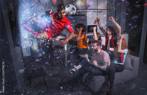 Group of friends watch a football match on television with a soccer player who exits from screen