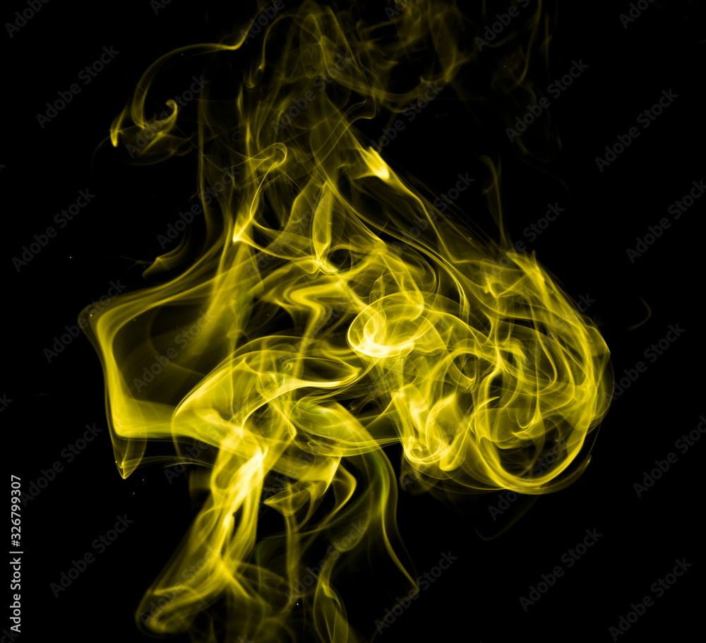 Obraz premium Yellow smoke on black background