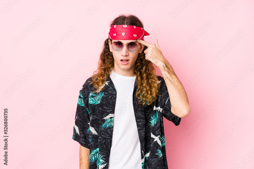 Young hippie caucasian man isolated showing a disappointment gesture with forefinger.