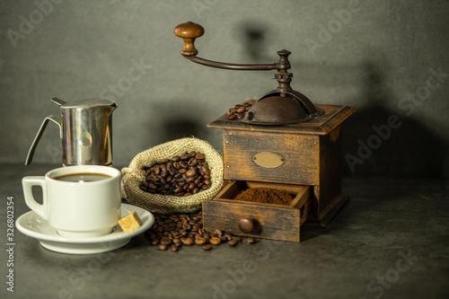 coffee grinder and beans on wooden background