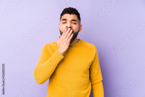 Young mixed race arabic man isolated yawning showing a tired gesture covering mouth with hand.