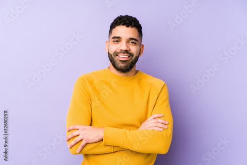 Young mixed race arabic man isolated who feels confident, crossing arms with determination.