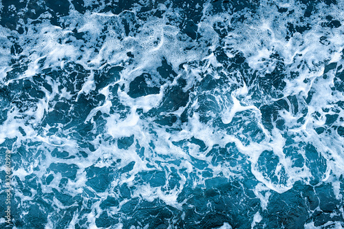 Fototapeta Naklejka Na Ścianę i Meble -  Aerial view of salt ocean waves. Blue water aqua sea background ot texture. Rippled spashing waves.