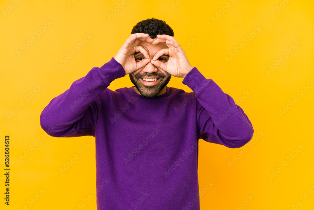 Young mixed race arabic man isolated showing okay sign over eyes Young mixed race arabic man isolated showing okay sign over eyes
