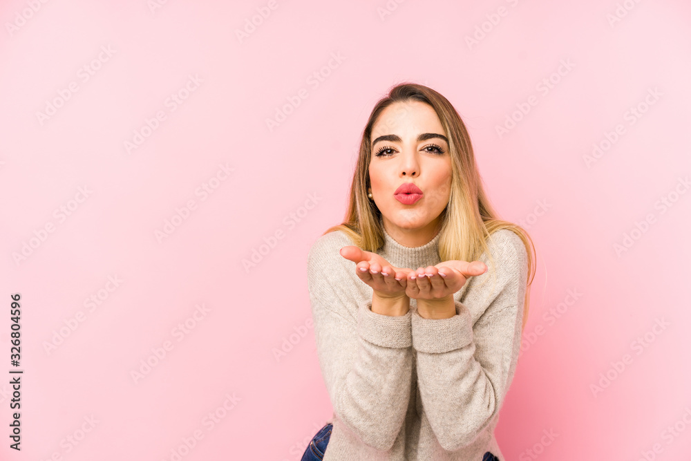 Middle age woman over isolated background folding lips and holding palms to send air kiss. Middle age woman over isolated background folding lips and holding palms to send air kiss.