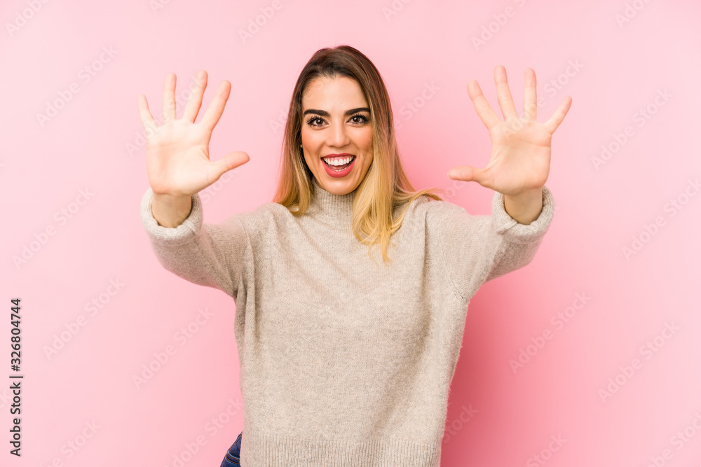 Middle age woman over isolated background showing number ten with hands. Middle age woman over isolated background showing number ten with hands.