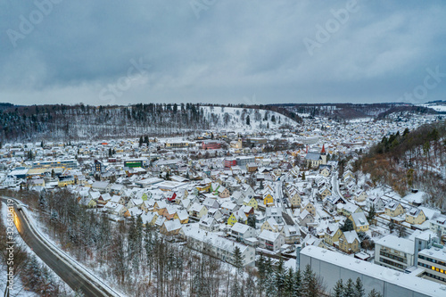 View over Albstadt, snow city at the Schwaebische Alb of germany in white powdered winter landscape aerial scene from a drone. photo