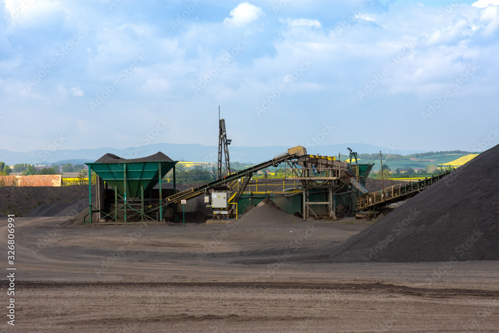 View of open-pit mine machinery with sifters and belt conveyors in basalt quarry