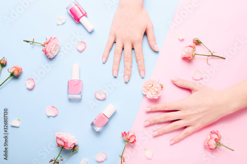 Beautiful woman manicure on creative trendy pink and blue background.