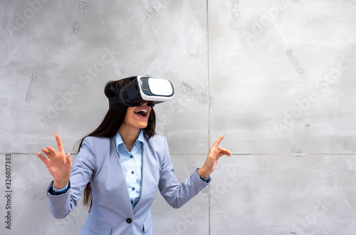 Businesswoman wearing virtual reality headset as concept for business digitization