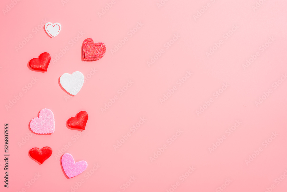 Blank pink background with red hearts for love and romantic compositions.