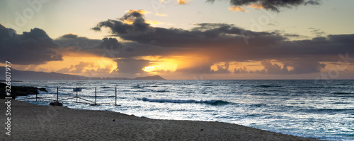 Long exposure seascapes of White Plains Beach at sunrise on Oahu Hawaii monotone and color blurred buety photo