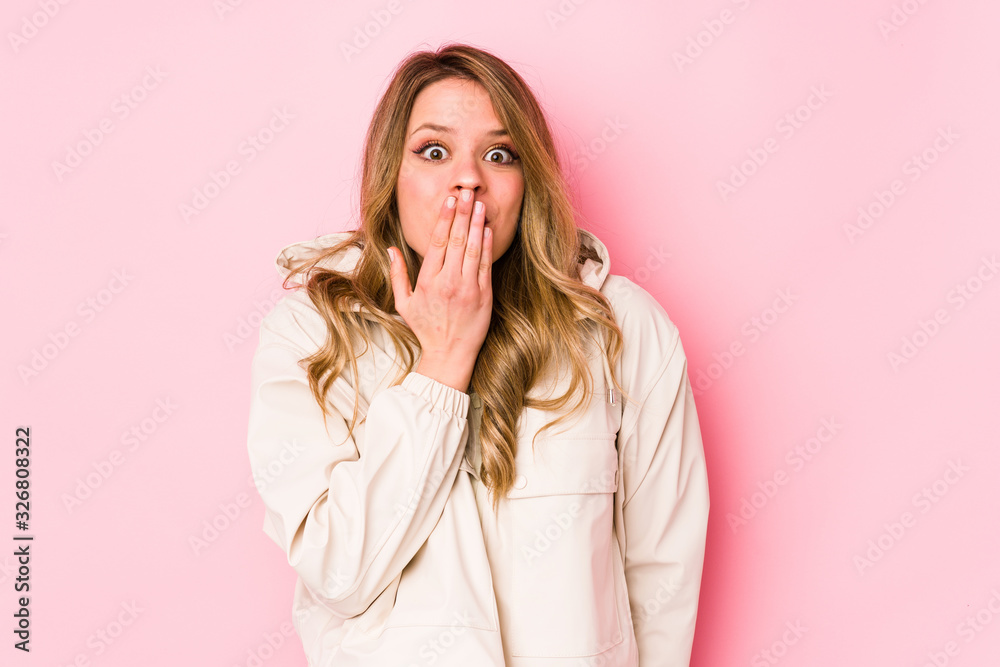 Young caucasian woman isolated on pink background shocked, covering mouth with hands, anxious to discover something new. Young caucasian woman isolated on pink background shocked, covering mouth with hands, anxious to discover something new.