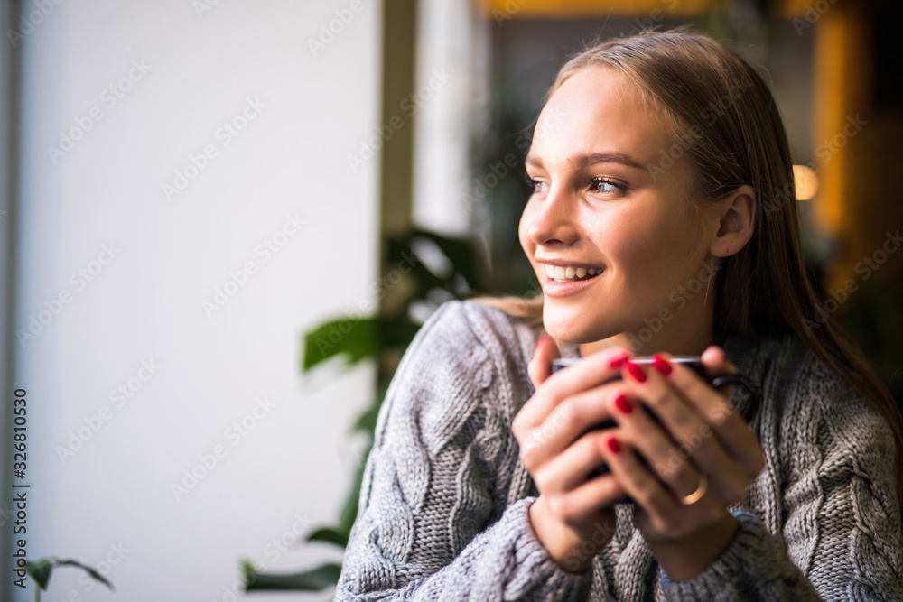 Portrait of beautiful mature woman drinking a cup of tea in cafeteria. Happy woman in a cafe drinking coffee and looking at camera. Portrait of smiling lady relaxing in a coffee shop. Portrait of beautiful mature woman drinking a cup of tea in cafeteria. Happy woman in a cafe drinking coffee and looking at camera. Portrait of smiling lady relaxing in a coffee shop.