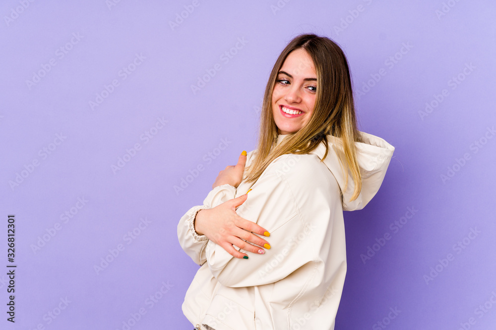 Young caucasian woman isolated on purple background laughing and having fun. Young caucasian woman isolated on purple background laughing and having fun.
