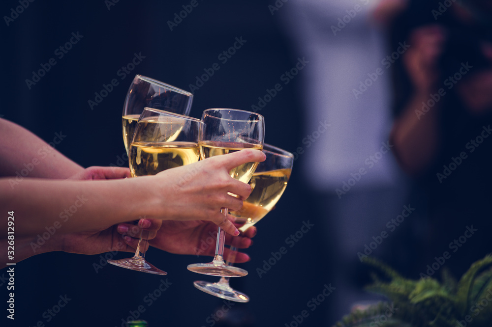 Cheers! Group of people cheering with champagne flutes with party background, Concept Celebration.