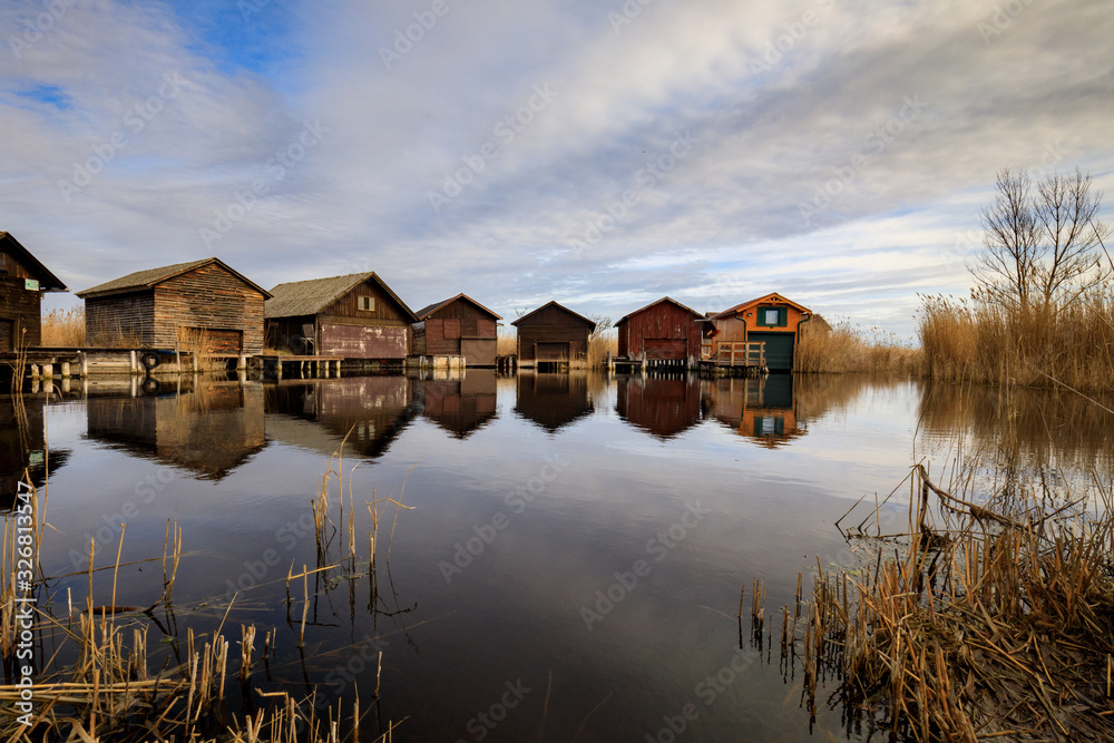 Neusiedler See, Lake Neusiedl. Bay with wooden pier and wooden cottage. Neusiedler See, Lake Neusiedl. Bay with wooden pier and wooden cottage.