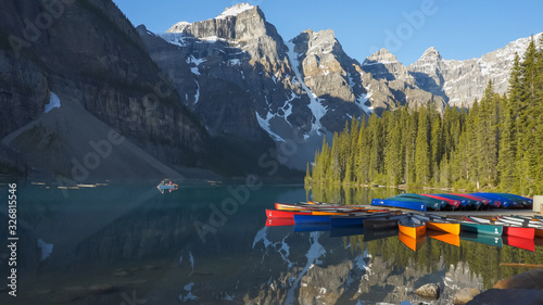 tourists paddling a canoe on moraine lake in banff np, canada