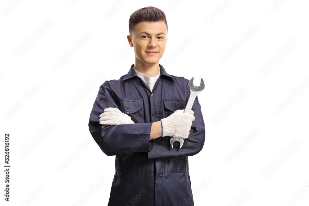 Young auto mechanic holding a wrench and looking at the camera Young auto mechanic holding a wrench and looking at the camera