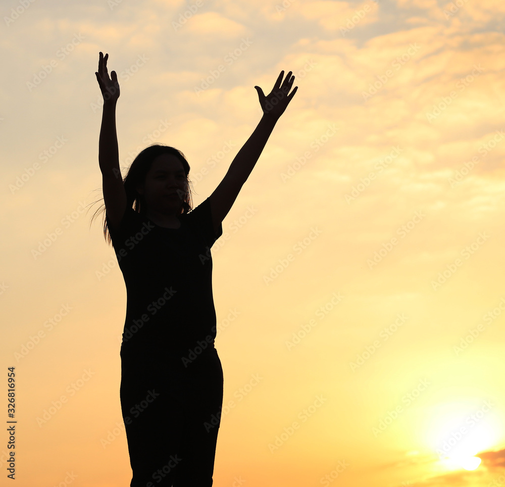 woman silhouette arms up to the sunset feeling happy and freedom. woman silhouette arms up to the sunset feeling happy and freedom.