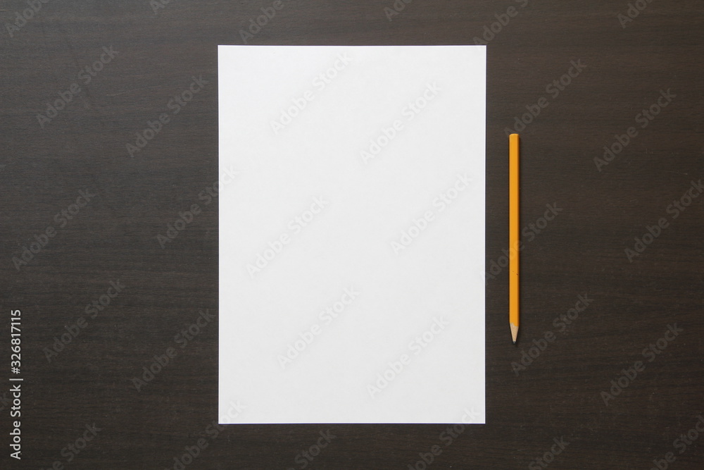 Template of white paper and pencil on dark wenge color wooden background. Template of white paper and pencil on dark wenge color wooden background.