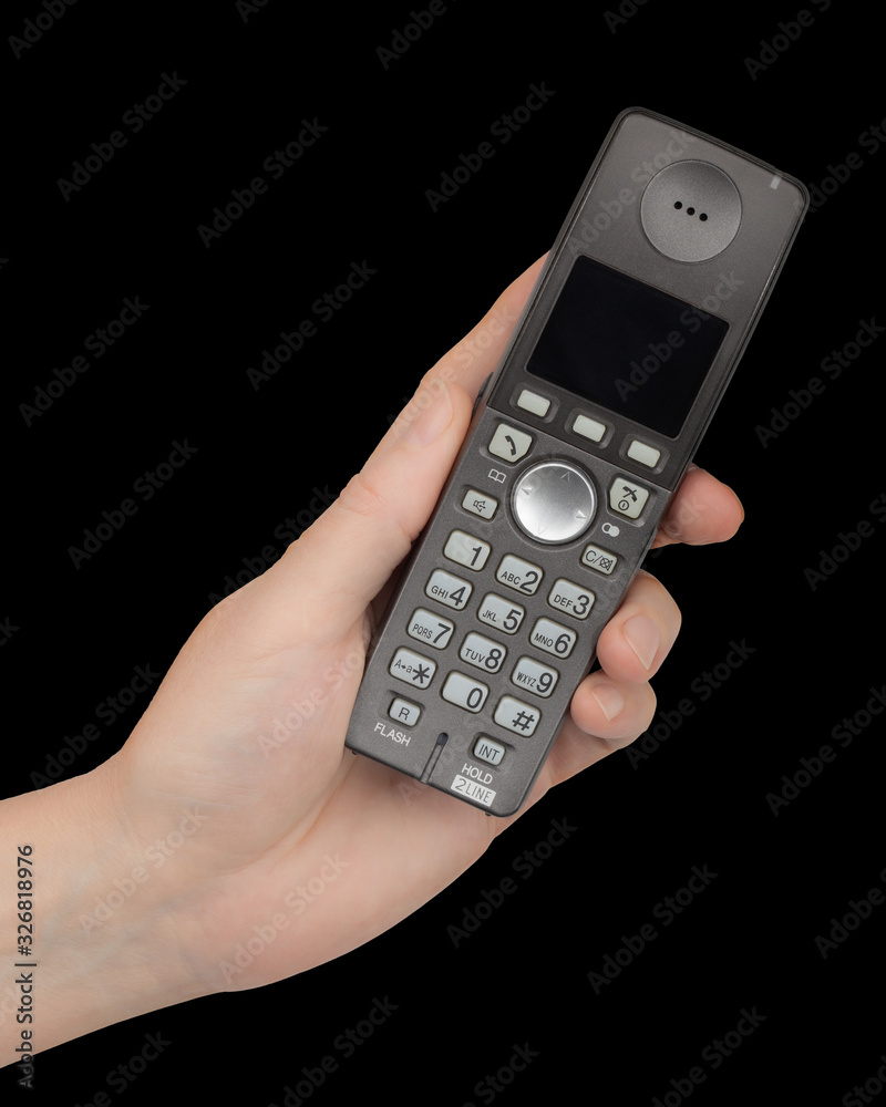 Female hand holds a phone, isolated on black background Female hand holds a phone, isolated on black background