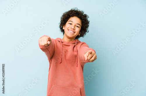 African american little boy isolated cheerful smiles pointing to front. photo