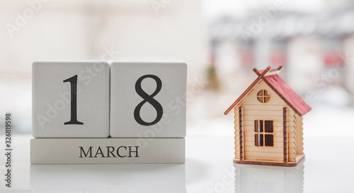 March calendar and toy home. Day 18 of month. Сard message for print or remember
