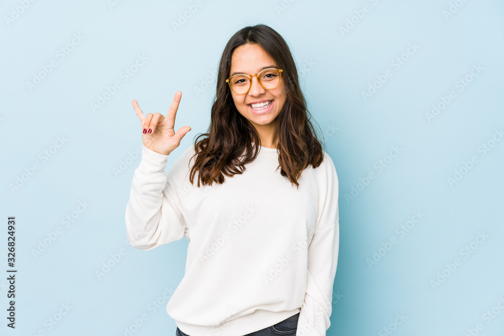 Young mixed race hispanic woman isolated showing a horns gesture as a revolution concept. Young mixed race hispanic woman isolated showing a horns gesture as a revolution concept.