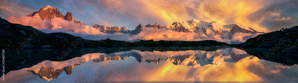 Mountains reflected on a lake in the French Alps, Chamonix at sunrise - obrazy, fototapety, plakaty 