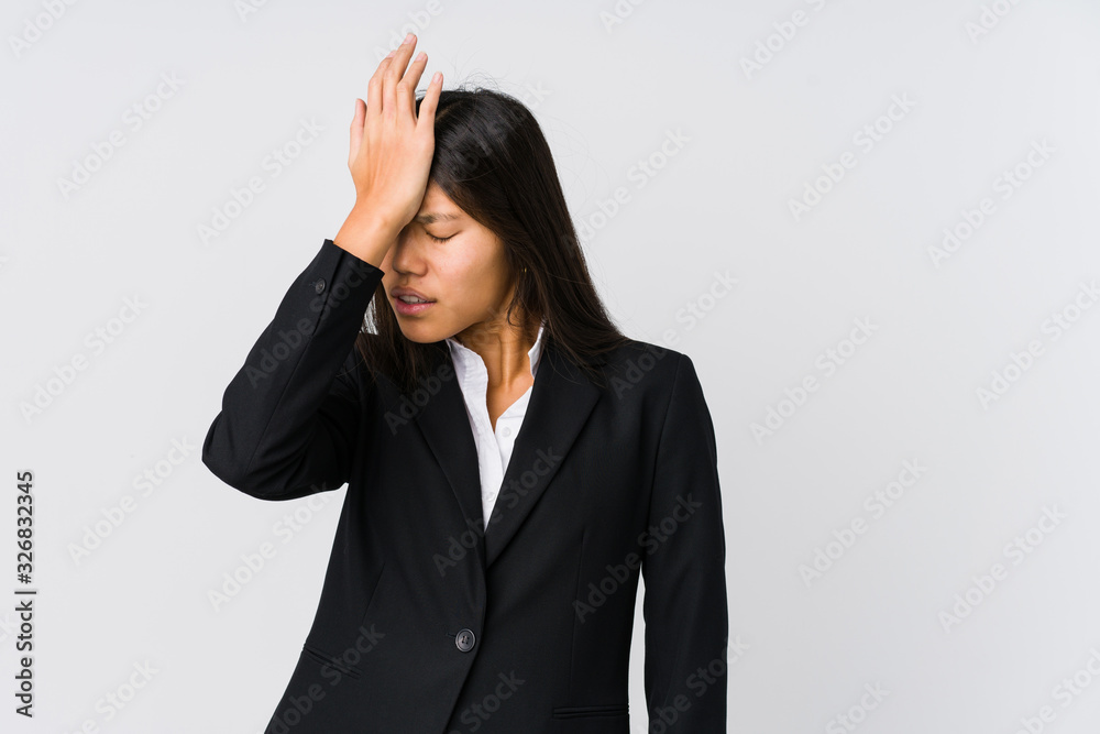 Young asian business woman forgetting something, slapping forehead with palm and closing eyes.