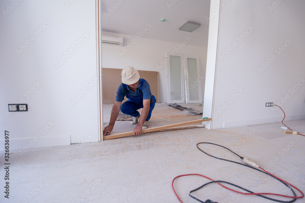 carpenters installing glass door with a wooden frame