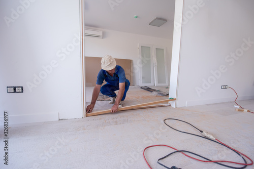 carpenters installing glass door with a wooden frame © .shock