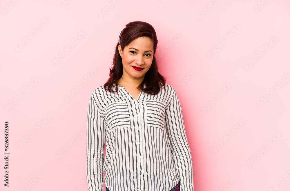 Middle age latin woman isolated on a pink background happy, smiling and cheerful. Middle age latin woman isolated on a pink background happy, smiling and cheerful.