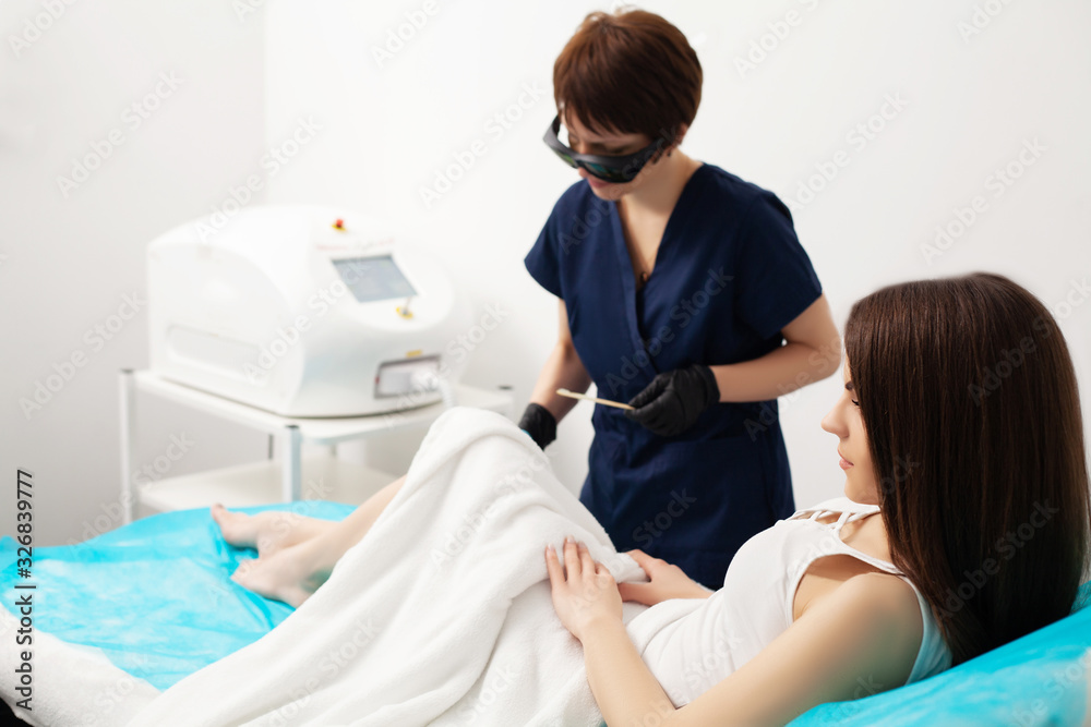 Fototapeta premium Woman getting laser treatment in a beauty salon