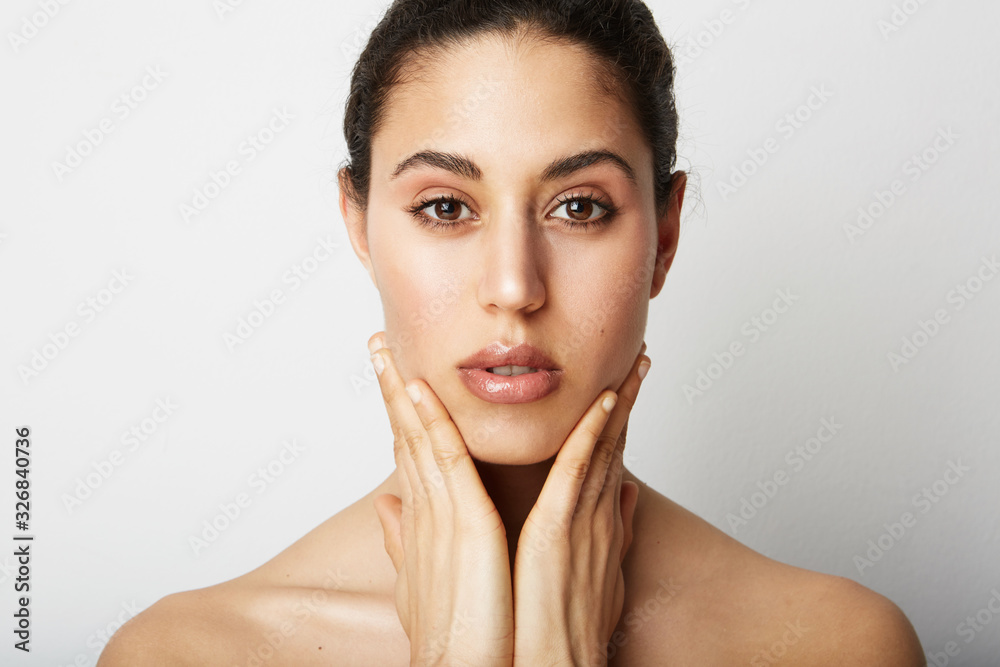 Beautiful young woman naked posing on the white wall. With positive emotions. Space for your text. Beautiful young woman naked posing on the white wall. With positive emotions. Space for your text.