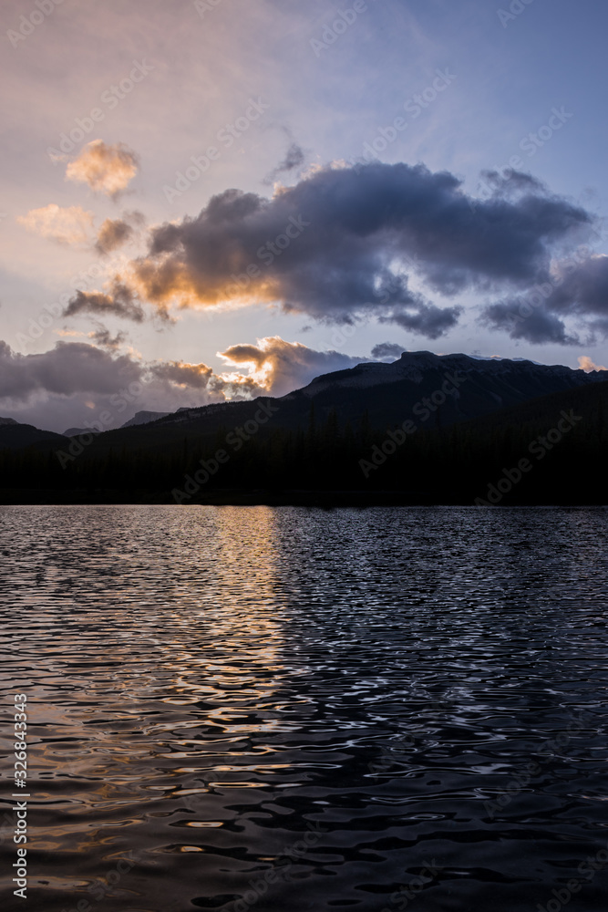 Golden sunset lake reflection in the rocky mountains Canadian landscape portrait