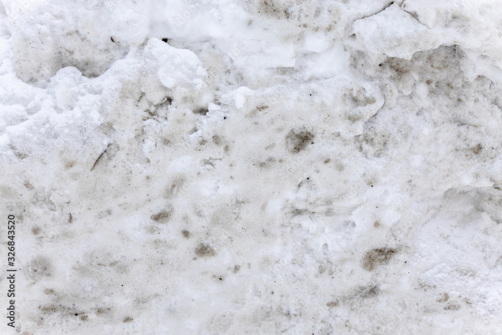 Obraz premium Dirty snow spring background. Spring time. Old and dirty snow texture. Natural background