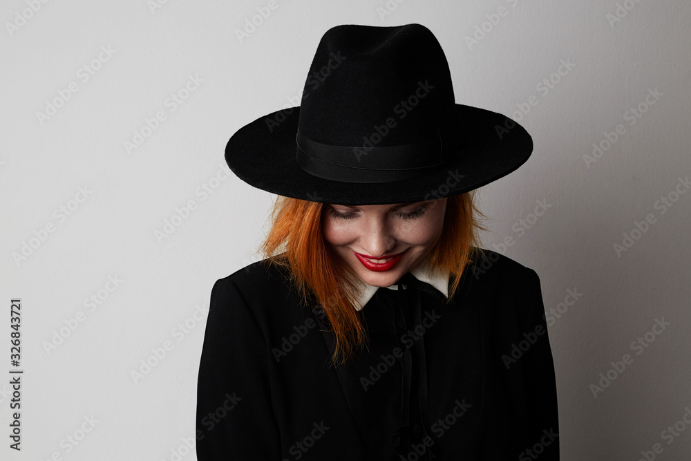 Young hipster woman smiling and posing on the white background.