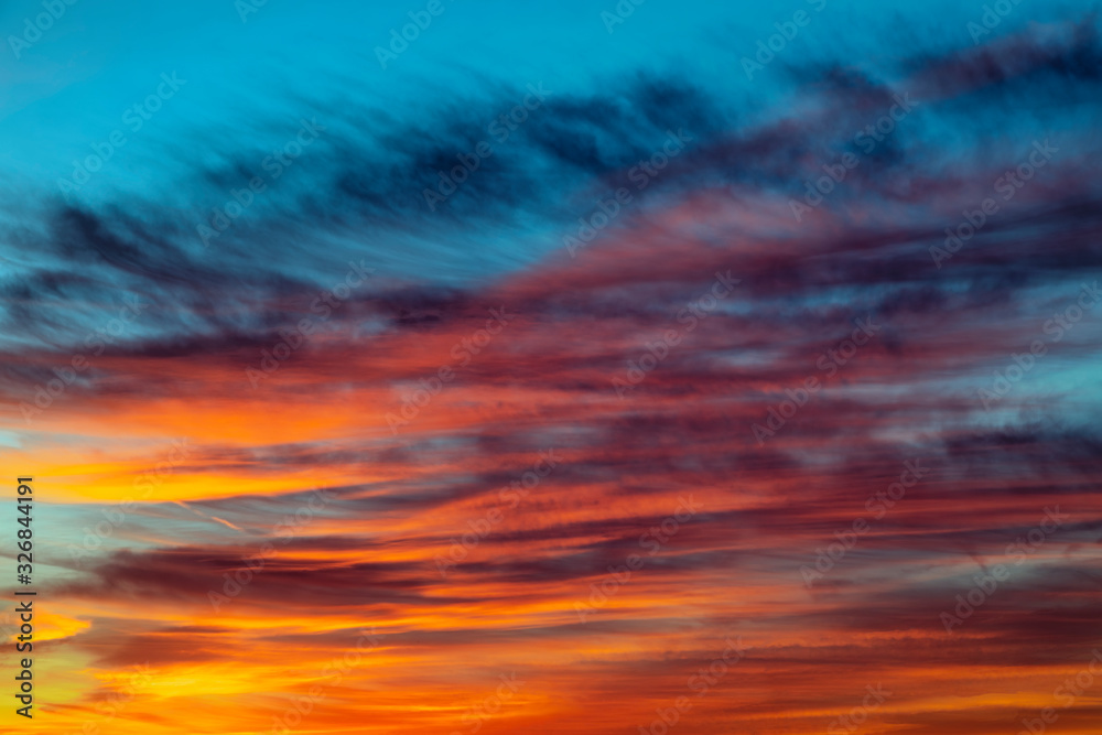 Colors in the Sundown Sky - Beautiful clouds are painted in vivid hues in a colorful sunset sky.