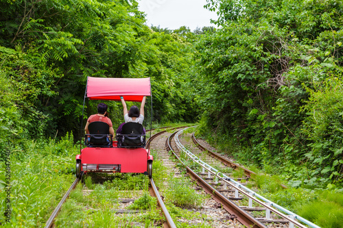 Happy tourist and enjoy the nature scene while pedal along old railroad tracks in Gangchon Rail Park in Chuncheon in South Korea