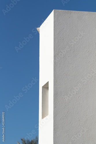 Minimal background in architectural style. White walls against the blue sky.