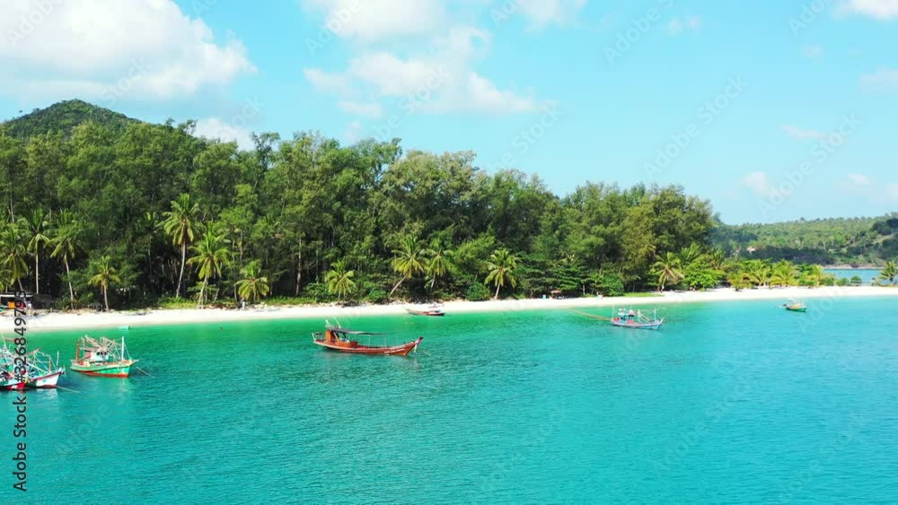 Beautiful calm tropical lagoon with fishing boats, turquoise water, palms and mountain in the background. Thailand, Beautiful calm tropical lagoon with fishing boats, turquoise water, palms and mountain in the background. Thailand,