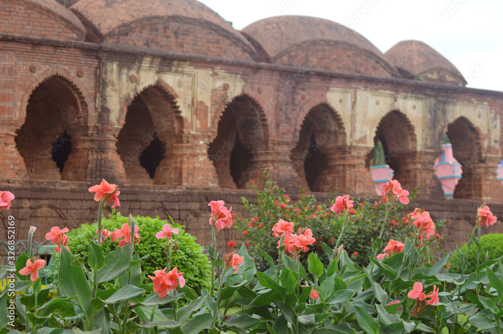 Obraz premium beautiful flower garden in front of an old temple