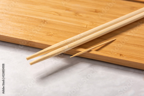 Disposable cutlery, toothpicks, chopsticks, napkins, plastic spoons on wooden trays