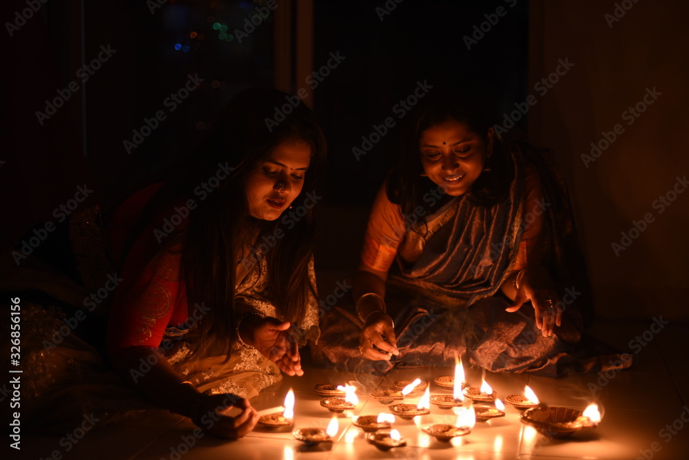 Two beautiful Indian Bengali women in Indian traditional dress are