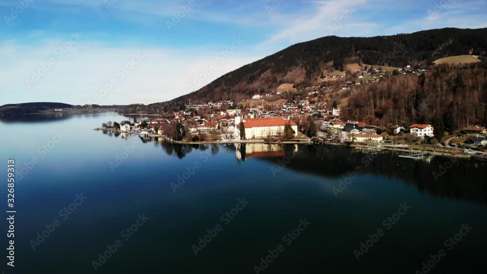 Panning aerial shot of a small city next to a blue and clear lake in germany Panning aerial shot of a small city next to a blue and clear lake in germany