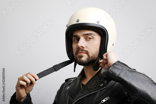 Close-up portrait of young biker with white helmet. Isolated.