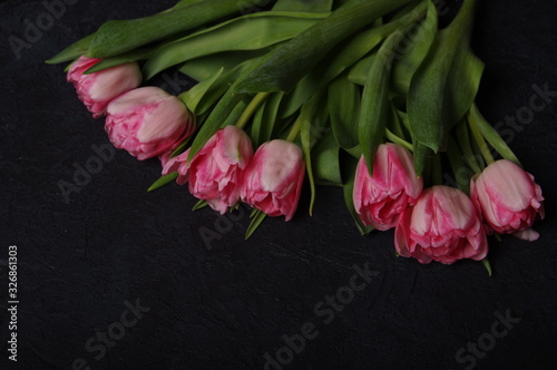 Yellow red tulips bouquet on black baclground